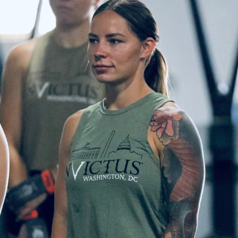 Woman with arm sleeve tattoo wearing muscle tank top